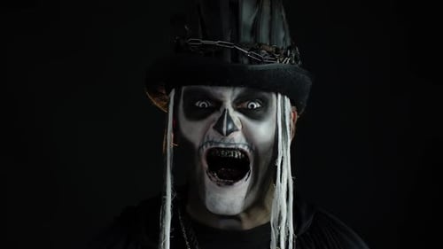 Creepy Man with Halloween Makeup Sticking Tongue Out