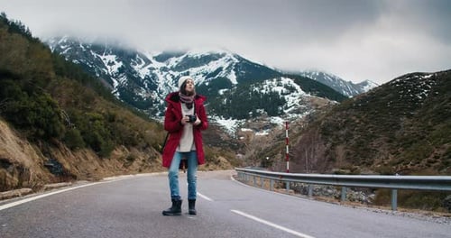Young Woman Travel Photographer Walk on Empty Mountain Road Making Photo