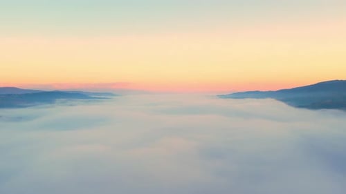 Aerial View of Foggy Landscape at Sunrise