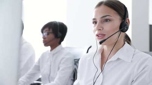 Call Center Agents Consulting Clients On Hotline At Office