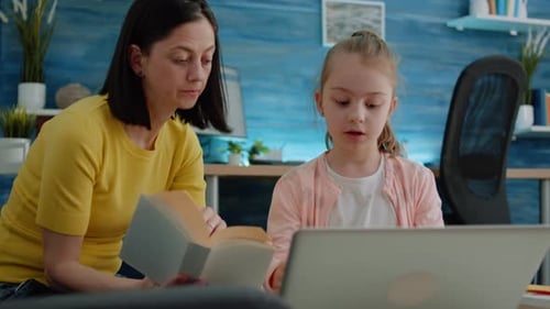Woman Helping Child with Schoolwork at Home