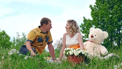 Loving Couple Enjoying a Picnic in a Field