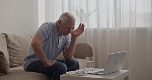 Senior Man Telehealth Call with Medication