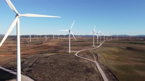 Windmills in field on sunny day