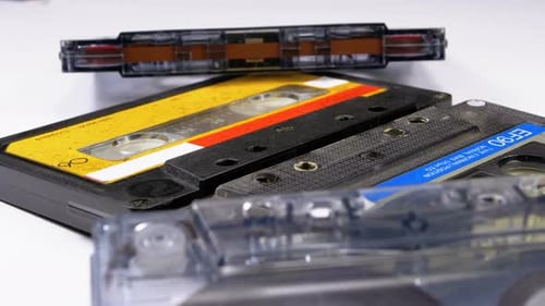 Four Audio Cassettes Rotate on White Background