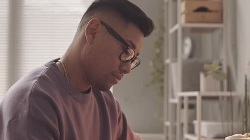 Adult Man Uses Tablet and Stylus at Desk