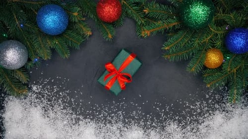 Woman's hands puts gift in the center of frame. Christmas decorations - flashing garland lights