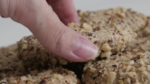 Pile of cookies, hand takes one