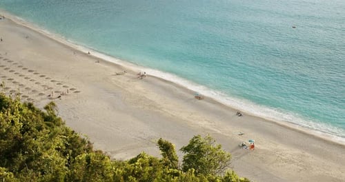 Beautiful Sandy Beach and Turquoise Colored Sea in Warm Morning Light