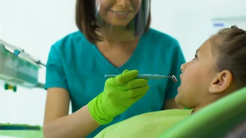 Dentist Examining Little Girl Teeth, Routine Dental Checkup in Modern Clinic