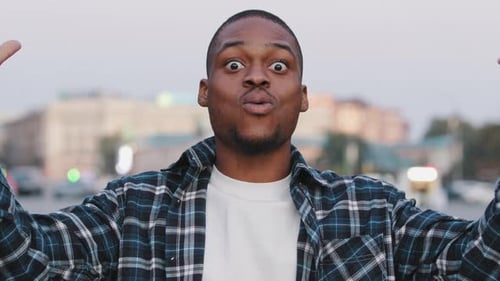 African American Happy Young Guy in Casual Tshirt Isolated in City Street Outdoors Looking at Camera
