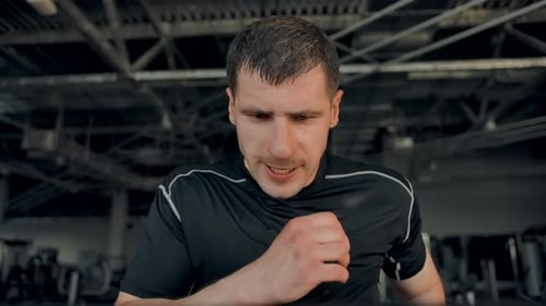 Man Works Hard on Treadmill at the Gym