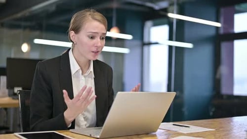 Woman Working On Laptop Gets Bad News