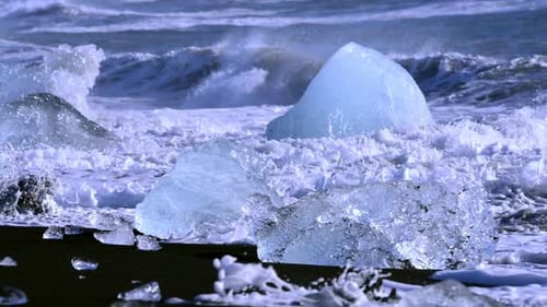 Ice From a Glacier Washing By Atlantic Ocean Waves on a Black Diamond Beach in Iceland. Climate
