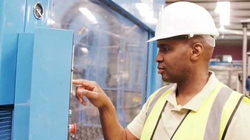 Smiling worker operating a machine