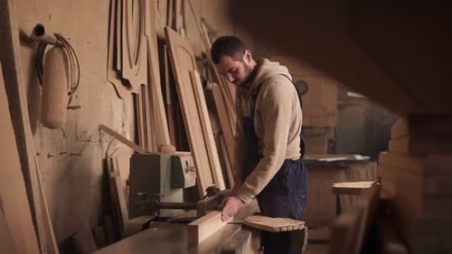 Man Using Woodworking Machine in Workshop