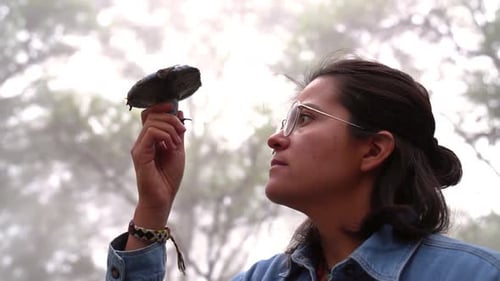 Woman with indigo milk cap mushroom in forest