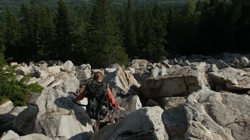 Young Woman Having an Adventure - Going Down the Mountain with Backpack on Her Back