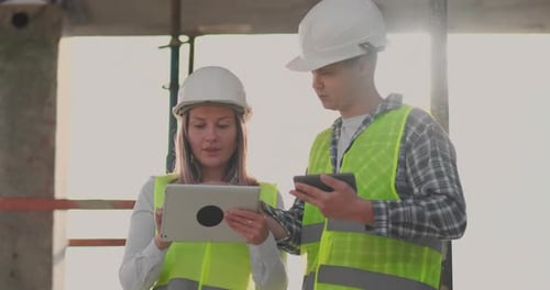 Engineers Designers Stand on the Roof of the Building Under Construction and Discuss the Plan and