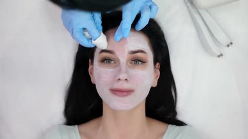 Woman Having Beauty Mask Removed From Face