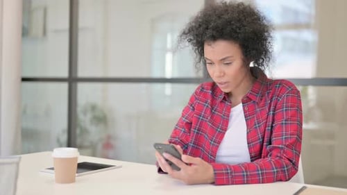 Frustrated Woman Reacts Negatively to Smartphone Message