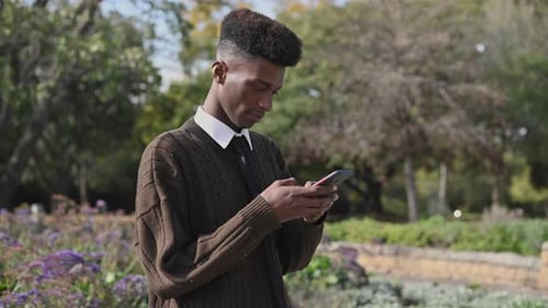 Close Up Shot of Young Man Using His Mobile Phone