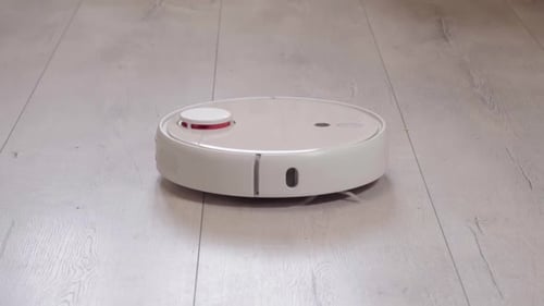 Modern Robotic Vacuum Cleaner Cleaning the Floor