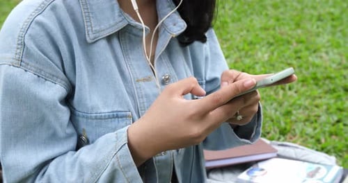 Woman Using Smartphone in Sunny City Park