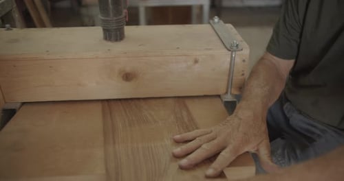 Man Smoothing Wooden Boards on Woodworking Machine