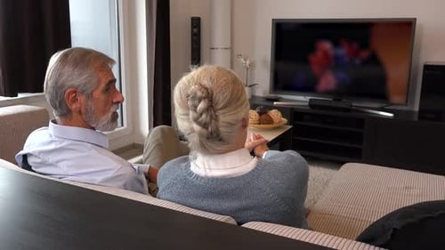 Senior Couple Relaxing, Watching TV at Home