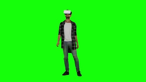 Man Wearing Virtual Reality Goggles. Studio Shot. Green Screen