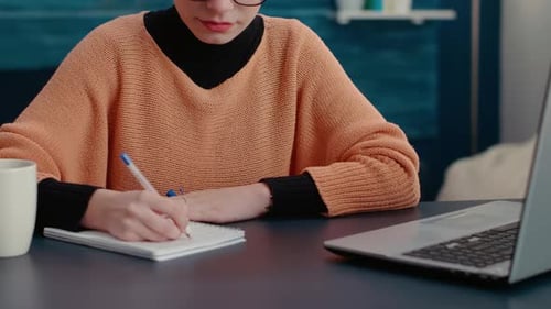 Portrait of College Student Taking Notes on Textbook
