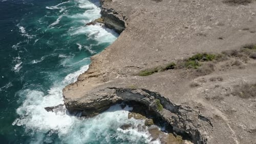 Pulling-In Drone Shot of the Panoramic Scenery of the Ocean Water and Rocky Cliffs