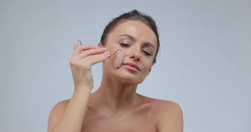 Woman Using Natural Massager Tool for Skin Care and Spa Beauty Treatment