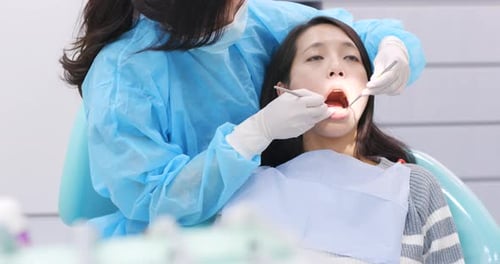 Dentist examining a patient teeth in the dentist