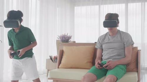 Boy and Young Adult Playing Video Games with VR
