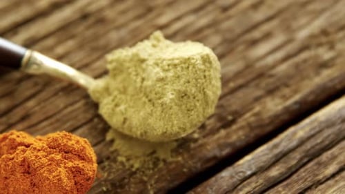 Red chili powder and coriander powder on a wooden table 4k