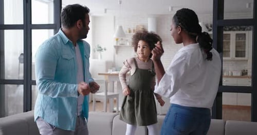 Happy Family Dancing Together at Home