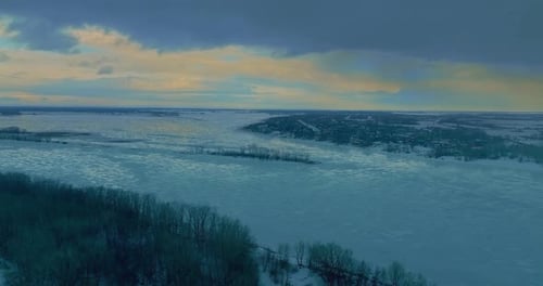 Copter Flies Over a Frozen Winter River Beautiful Patterns on the Ice