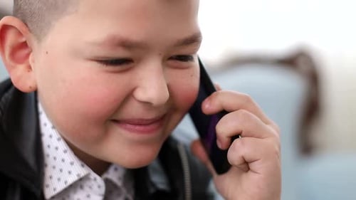 Boy Smiling and Talking on a Cell Phone