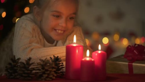 Happy Child Gazing at Christmas Candles