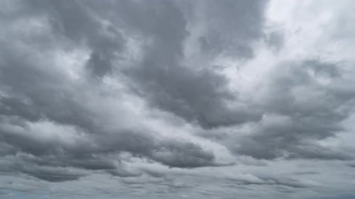 Dramatic Billowing Gray Clouds Sweeping Across Sky