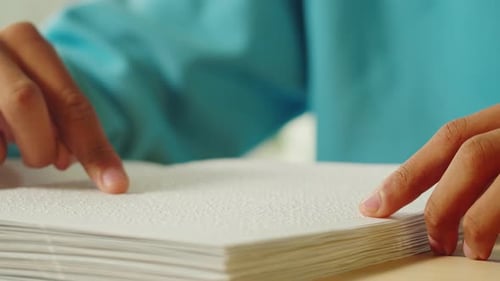 African American Man Reading Braille Book Closeup