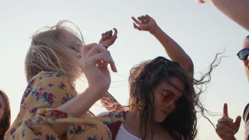 Des jeunes dansent sur la plage