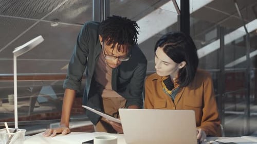 Multiethnic Colleagues Discussing Business Document in Office