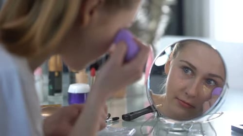 Young Woman Applying Makeup at Home