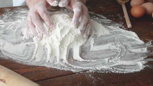Hands Working Flour on Wooden Table