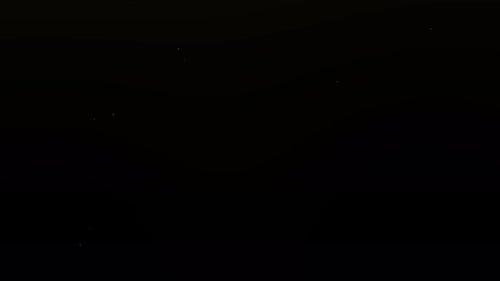 Abstract Particles Shimmering on a Dark Background