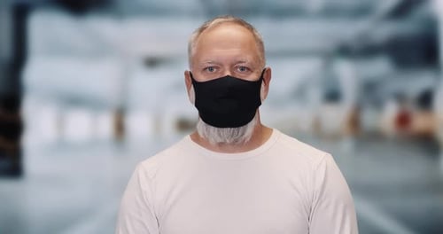 Adult Man Wearing Black Face Mask Indoors