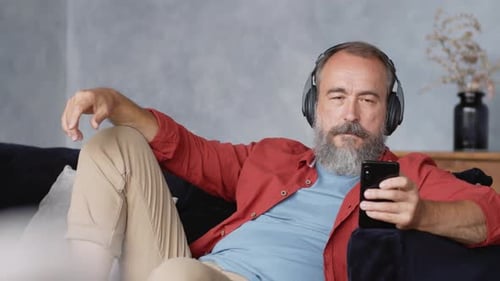 Man with Headphones Relaxing with Music at Home